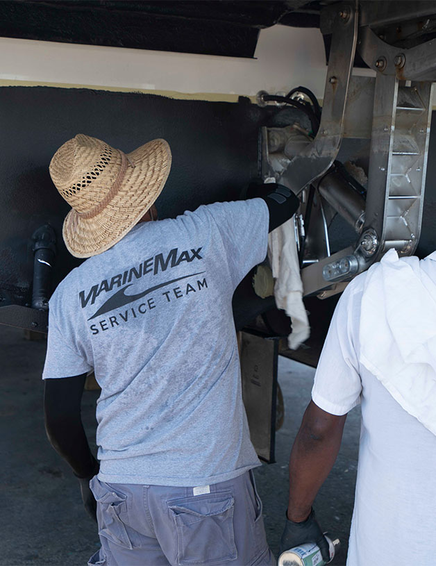 Man working on mechanicals of boat