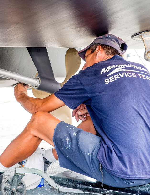 MarineMax Service Team member working on a boat