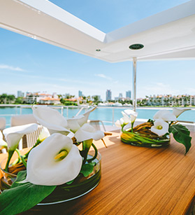 Table with flower arrangements on a Benetti yacht