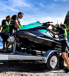 Group of people taking Kawasaki jet ski out onto the water