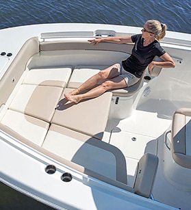 Woman lounging onboard of a NauticStar boat