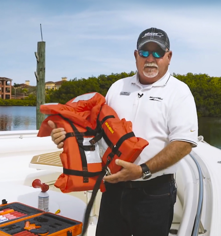 Captain holding a life jacket for boat safety