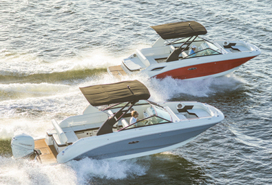 two boats driving next to each other