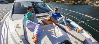 Couple lounging on the front of a boat