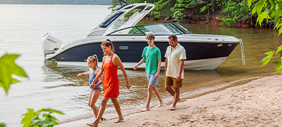 Couple people walking by a boat