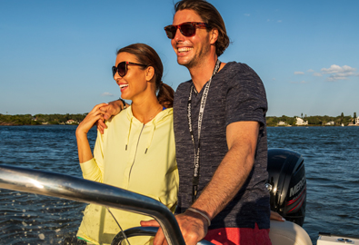 A couple at the helm of a boat