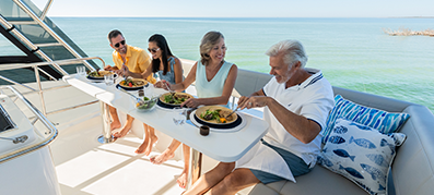 Couple of friends enjoying a meal on a boat