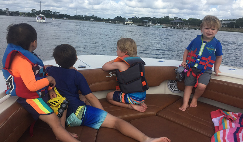 marinemax charleston educational program kids in boating classes four small kids in life jackets on a boat