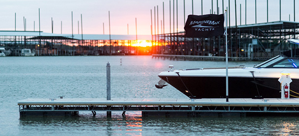 MarineMax Dallas Yacht Center yacht docked with a sunset view