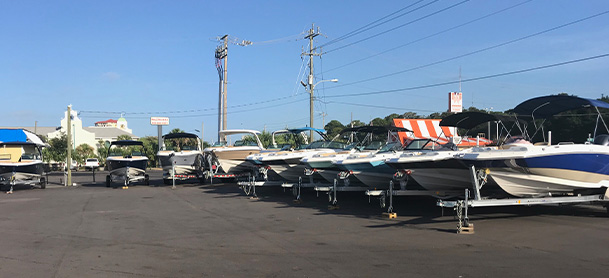 A row of boats in the parking lot of the MarineMax Fort Walton Beach store