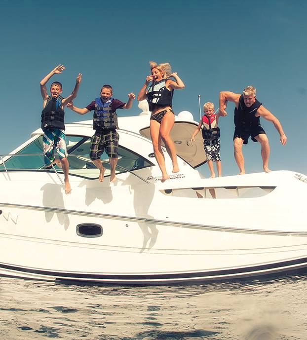 family jumping off boat