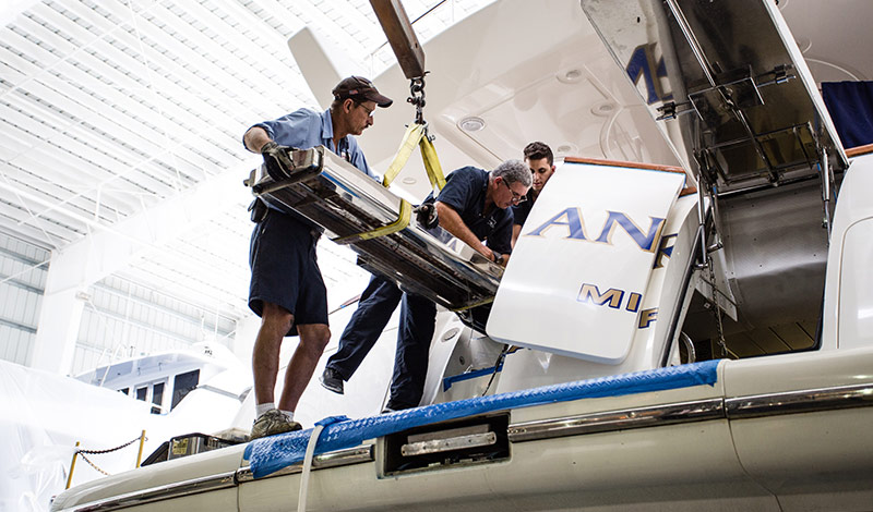marinemax st petersburg team members working on a yacht at service center