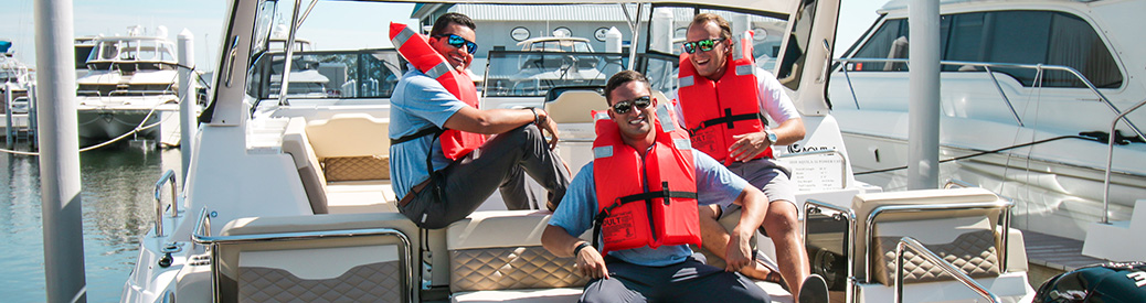 MarineMax St. Petersburg team members life jackets on a boat