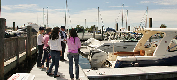 MarineMax Westbrook educational program Women on Water, women on a dock next to boats