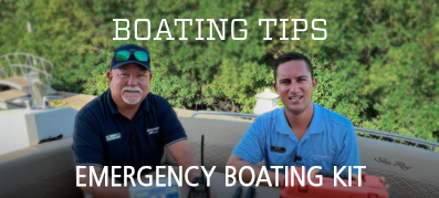 Captains Keith and Nick sit on the back of a Sea Ray boat with an emergency kit in front of them.