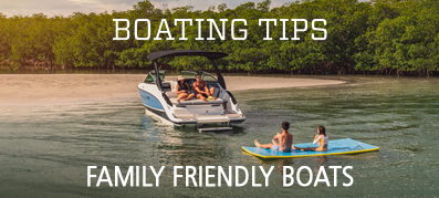 A family enjoys swimming around an anchored boat