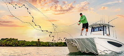 A man casts a casting net off an Aquila 28 Molokai 