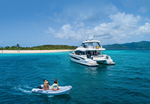 MarineMax yacht on the water with a small boat nearby