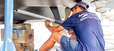 A marinemax team member repairs a boat