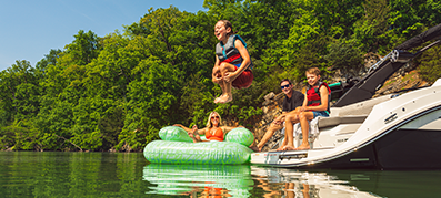 a family enjoying warm weather on the lake