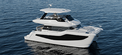 The recently announced Aquila 46 power catamaran yacht glides through calm blue waters.