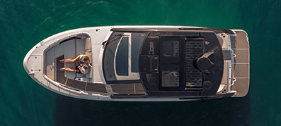 Overhead view of a boat on dark turquoise waters