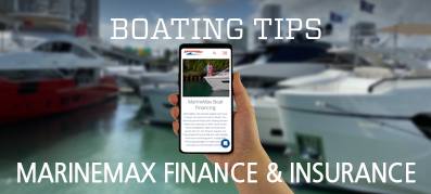 A hand holds a phone displaying the MarineMax Insurance and Financing page