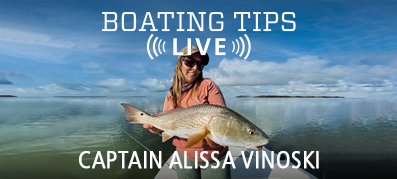 Captain Alissa Vinoski holding a fish