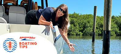 Captain Alissa leaning over a boat to the water