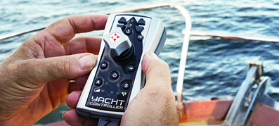 A hand holds a yacht controller device