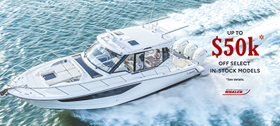 Aerial view of a Boston Whaler cruising on turquoise water with white wake trails