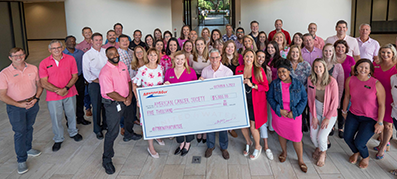 Group of MarineMax team members with donation signed to American Cancer Society 
