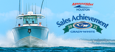 A large boat cuts through ocean waves under a clear blue sky. The text reads "MarineMax Houston Sales Achievement 2025 Grady-White," conveying success and celebration.