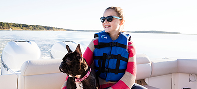 Girls with her dog on a boat