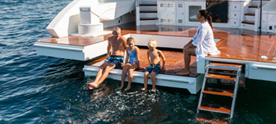 people sitting at the bow of a yacht