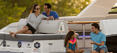 family sitting and laughing on boat 