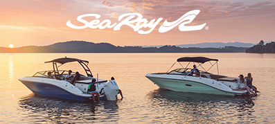 Two Sea Ray boats on the water with the Sea Ray logo at sun set