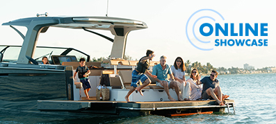 family sitting and laughing at the bow of a boat