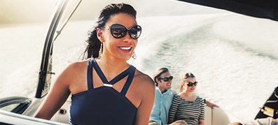 A woman piloting a boat on the water