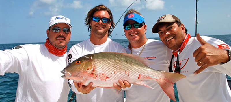 4 men holding a fish
