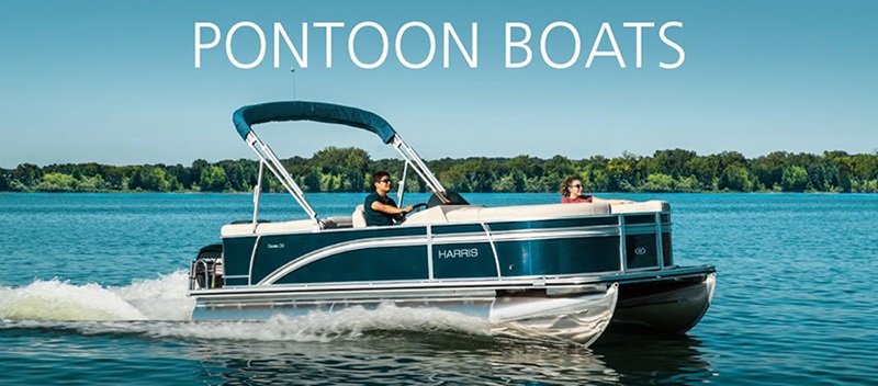 PONTOON BOAT - Harris Pontoon Boat gliding through water with man driving and woman sitting relaxing