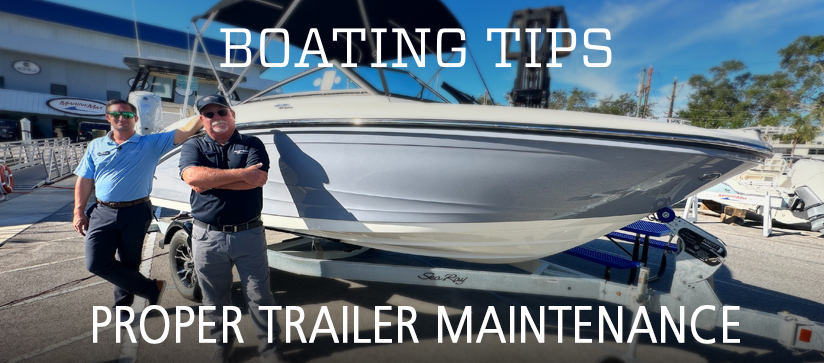 Captains Nick and Keith pose in front of a blue and white boat