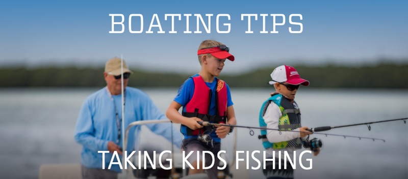 an adult and two children fish off an anchored boat