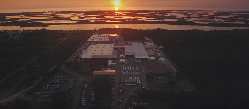 sun setting over water, islands, and large building