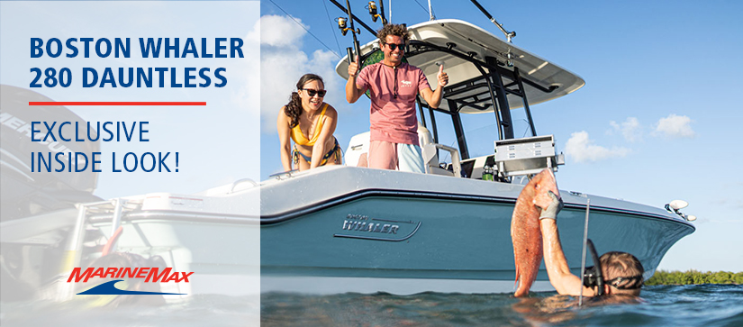 blue and white Boston Whaler Dauntless in the water with family around