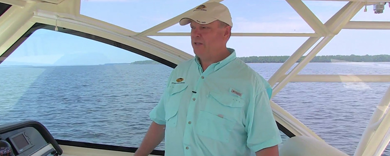 Man wearing a blue shirt on board of a boat - Why Buy a Grady-White Video