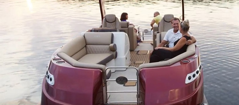 two couples sitting and talking on a boat