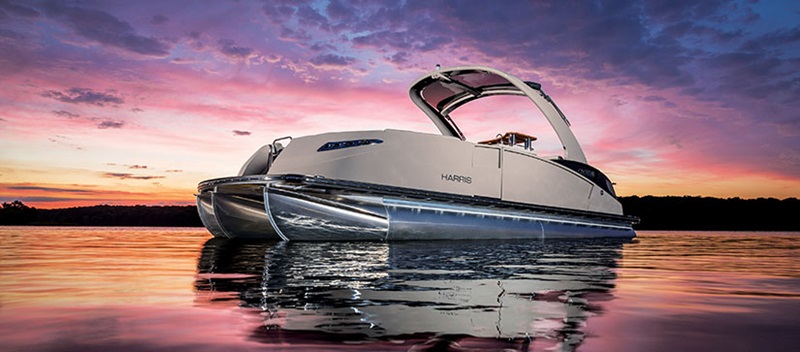 A Harris pontoon with a sunset on the background