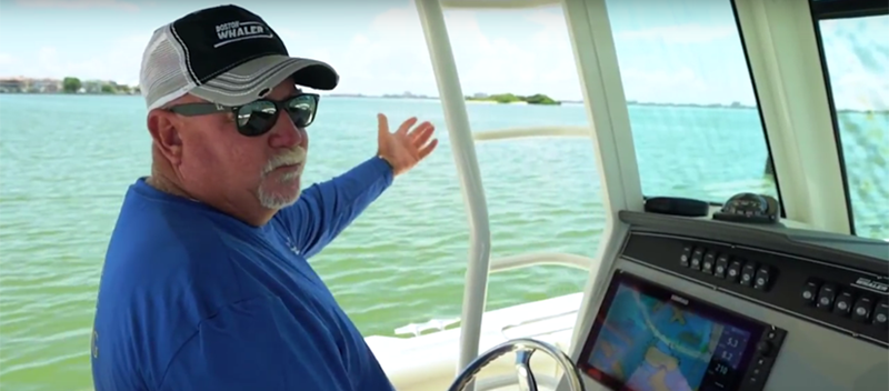 Man driving a boat and pointing out - Learn to read channel markers