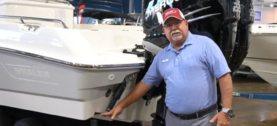 Captain Keith standing beside a trim tab on a boat